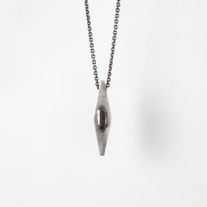 Handcrafted gray-oxidized sterling silver pendant set with raw green tourmaline crystal