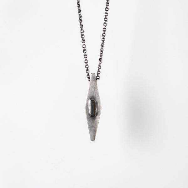 Handcrafted gray-oxidized sterling silver pendant set with raw green tourmaline crystal