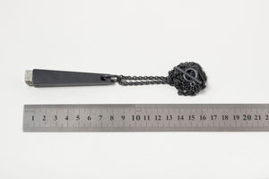 Black pyrite talisman with ruler for scale